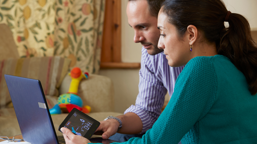 Close up of couple reviewing smart meter