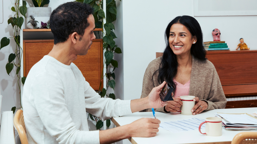 Couple reviewing smart meter and taking notes