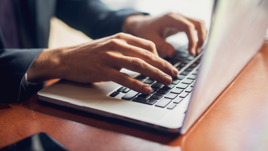 Typing on a laptop