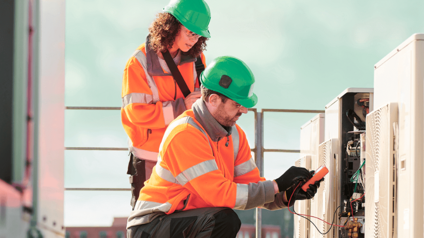 A male and female engineer assess the electrical load of a building